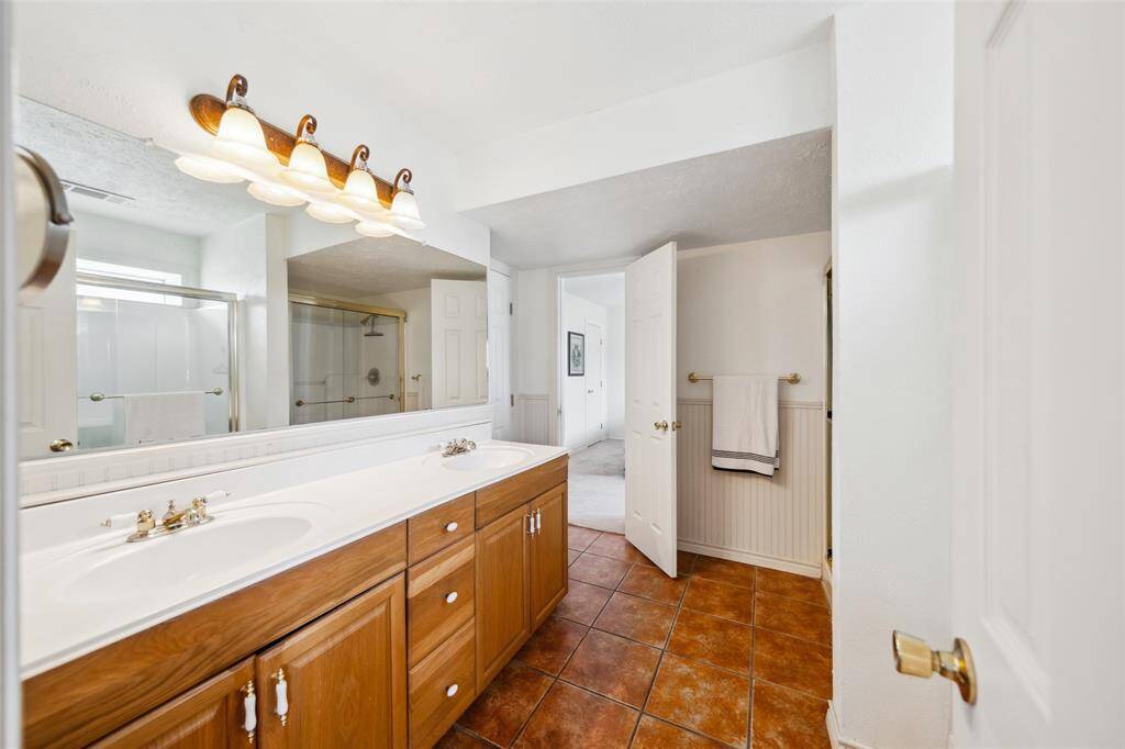 Bathroom has 2 sink vanity and water coset