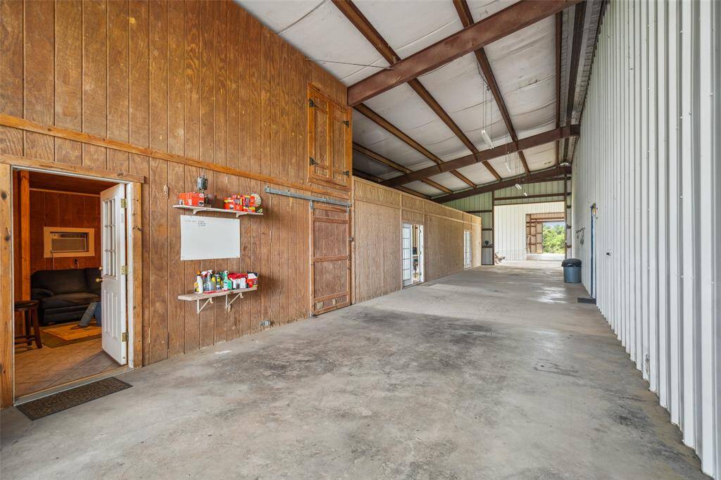 Covered concrete breezeway between main living area and game room, pool, and apartment