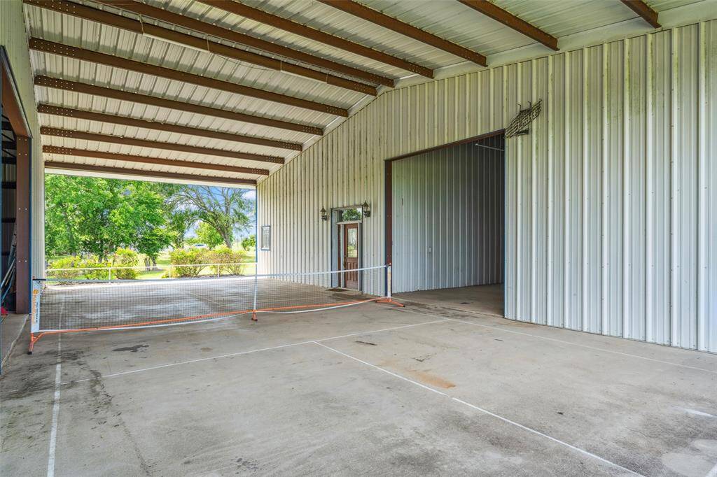Regulation size Pickle Ball Court is located in the covered breezeway between main living area and stalls