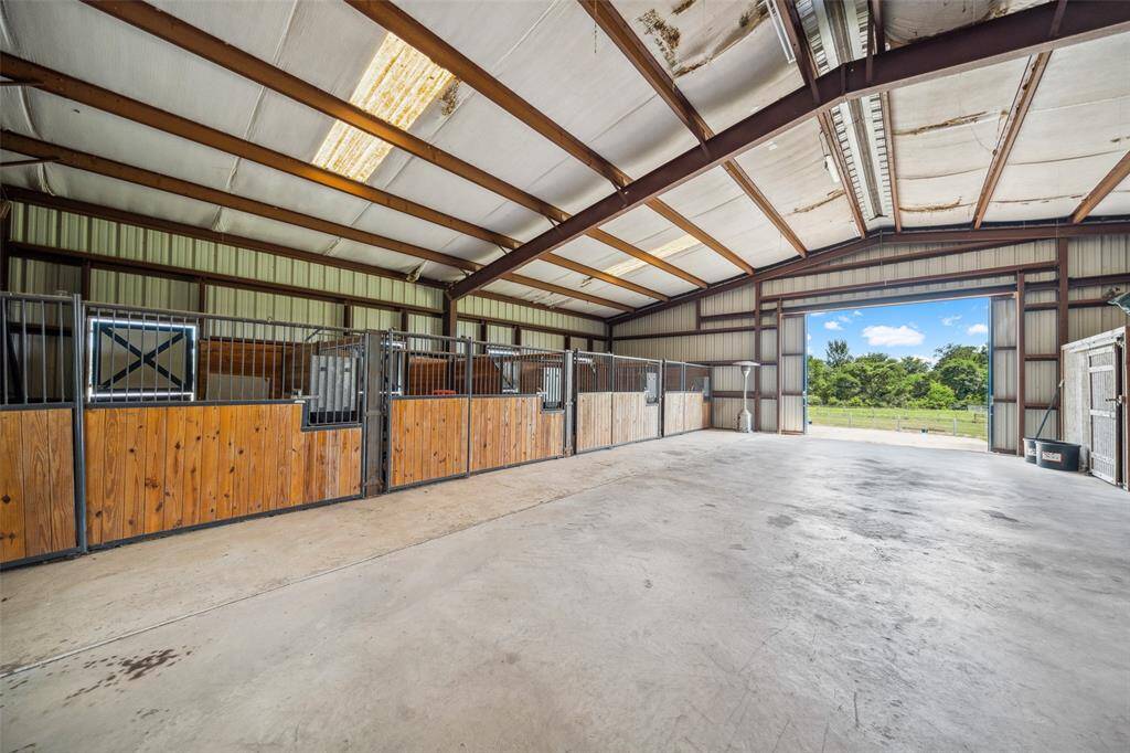 Four 12'x14' horse stalls w/turn out paddocks are located in the south end of the Barndo with  tons of additional storage area for implements/trailers.