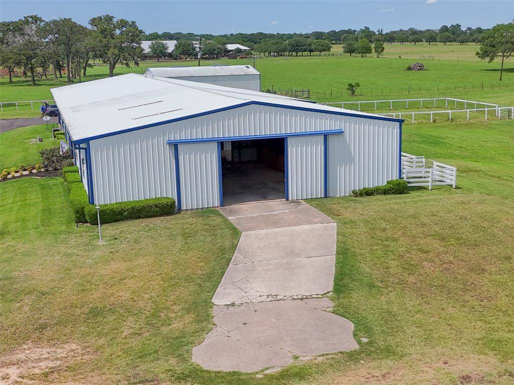 View showing the south entrance of Barndo with concrete drive and oversized doors.