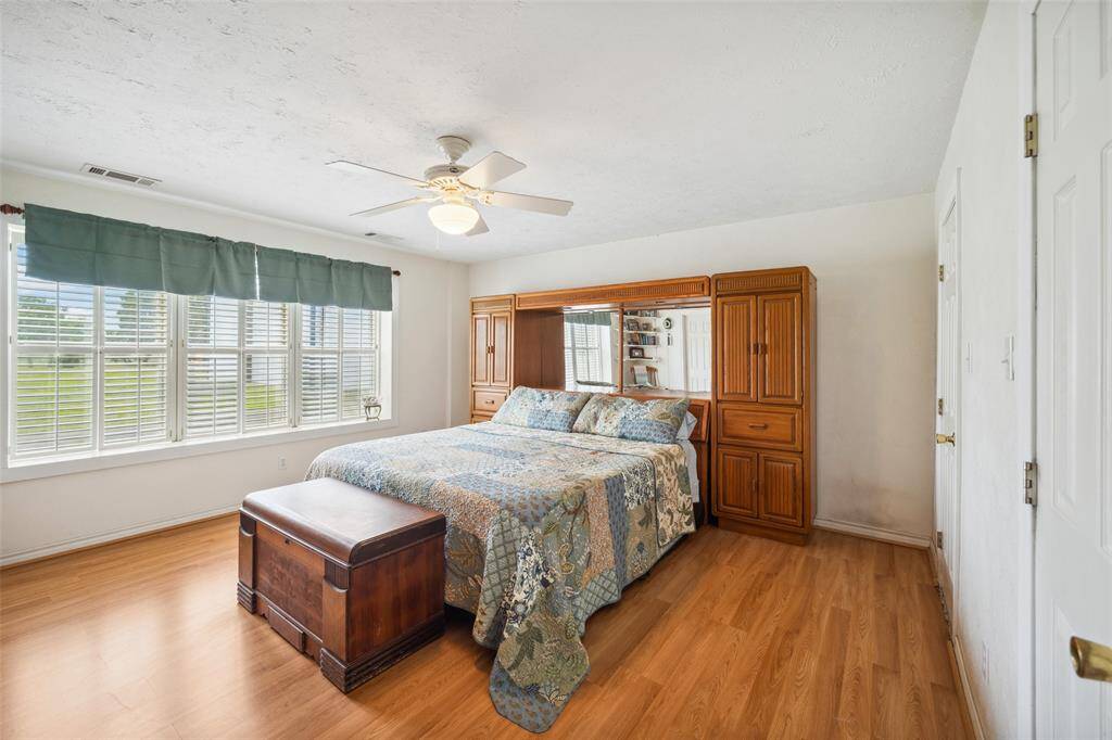 Bedroom #1 in Barndo with ceiling fan and views of the front yard.