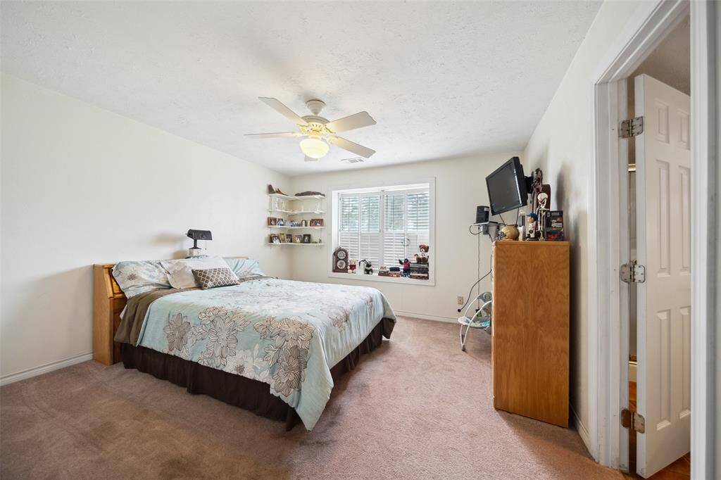Bedroom #2 in Barndo with ceiling fan and views of the front yard