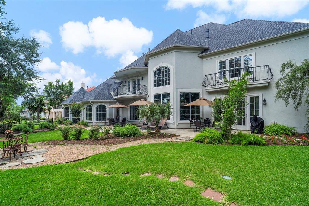 Come and see this spaciousbackyard with patio, paved walkways, and lovely landscaping.