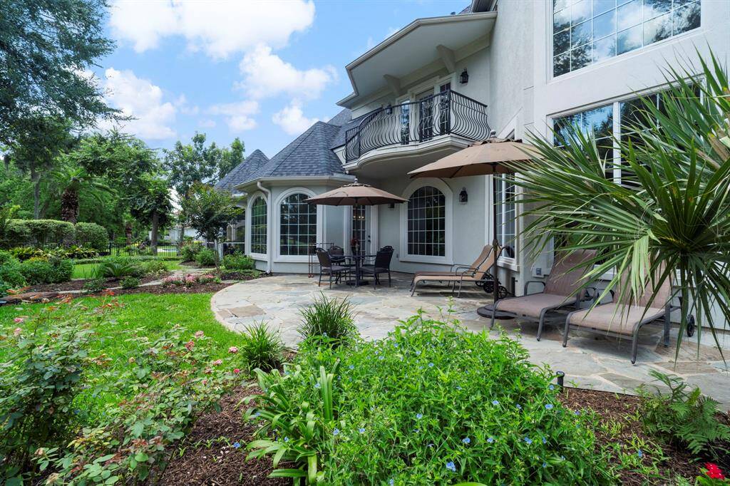 The backyard has French drains, a sprinkler system, terraces, slate pavers, access to primary bedroom and kitchen, and more!
