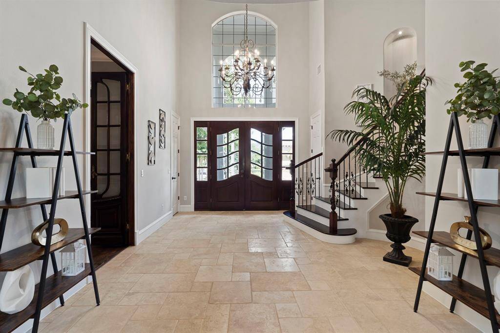 The entryway has high ceilings and plenty of natural lighting.