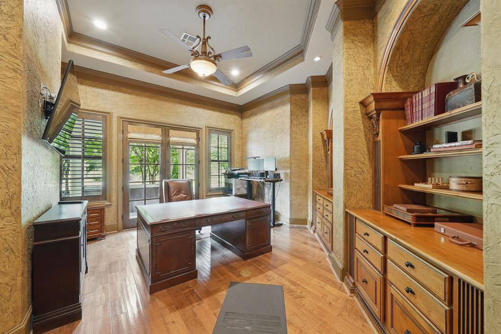 Transform your work routine into ahaven of productivity and comfort inthis thoughtfully designed homeoffice. Featuring beautiful floors, high ceilings, custom paint, built-in shelving, and access to the covered patio.