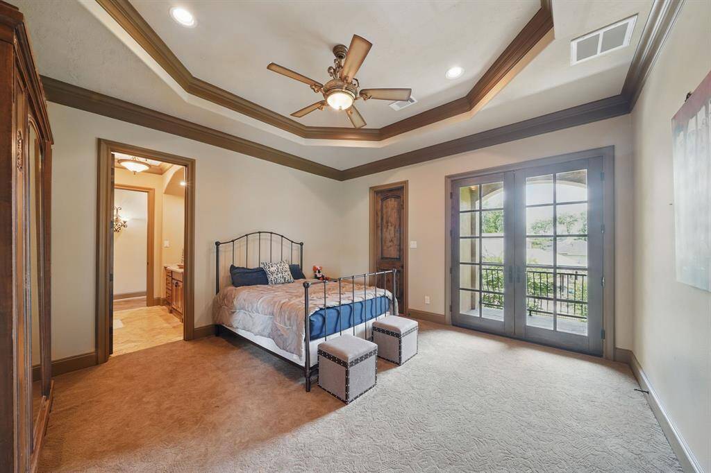 Secondary bedroom features access to the balcony, high ceilings with recessed lighting, en-suite bathroom, and plush carpet.