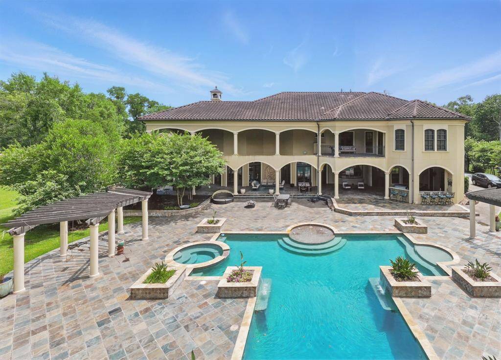 The pool has relaxing water features and a spa.
