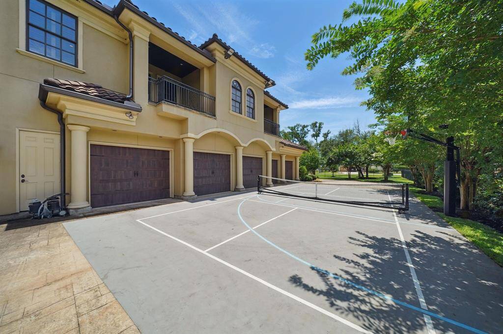 The 5 car garage has plenty of parking space and a pickleball/basketball court.