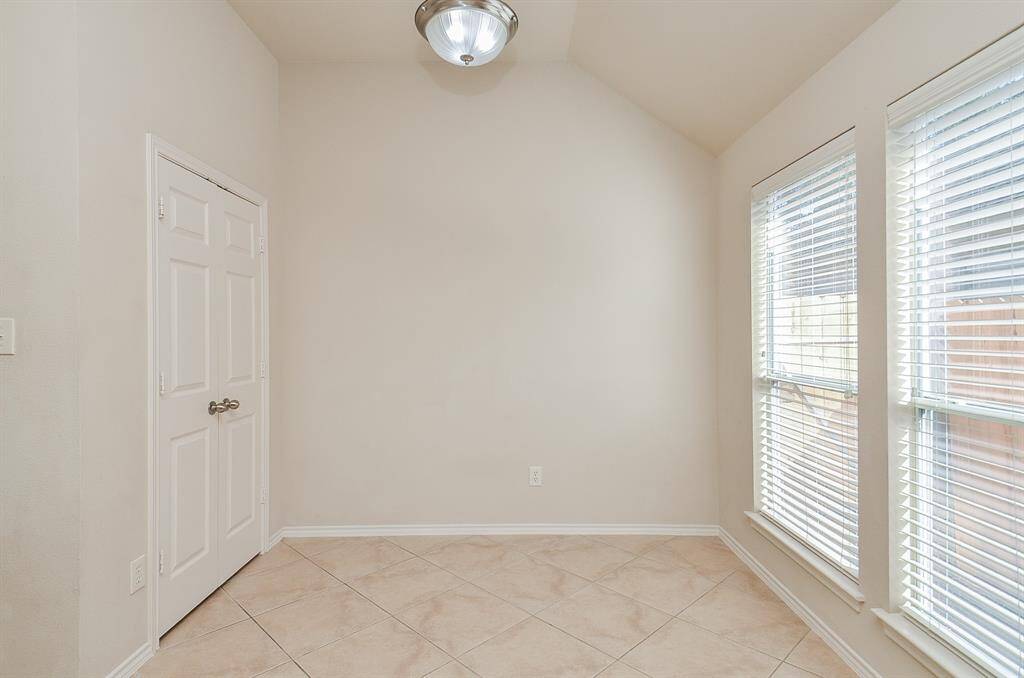 The breakfast area features two large windows that bring in natural light.