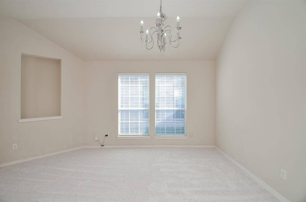 Formal Dining features beautiful flooring, tall windows & a classic chandelier.