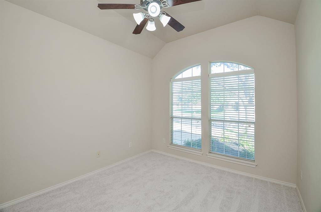 Bedroom 2 features an elegant arched French windows.