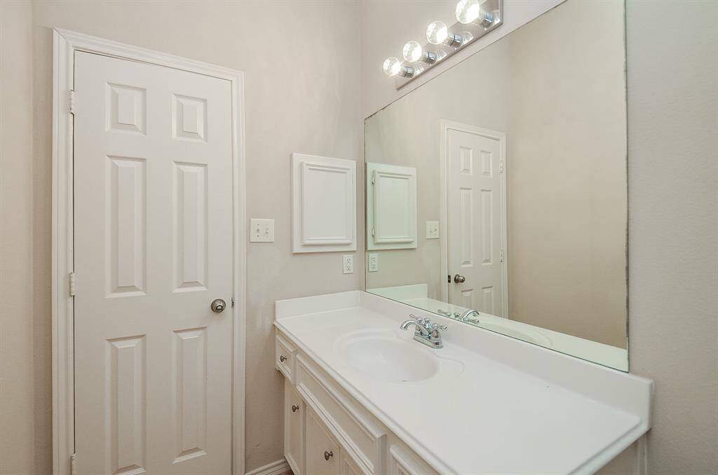 Secondary bathroom showcasing a single vanity sink with a gorgeous white countertop and matching cabinets for a clean, modern look.