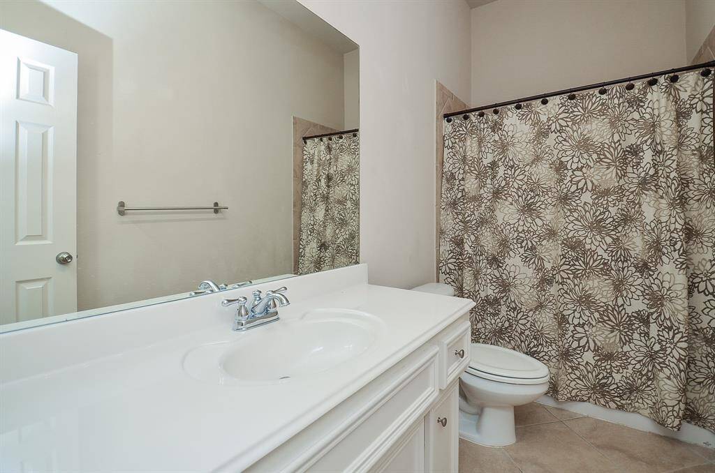 Secondary bathroom with a convenient tub and shower combo