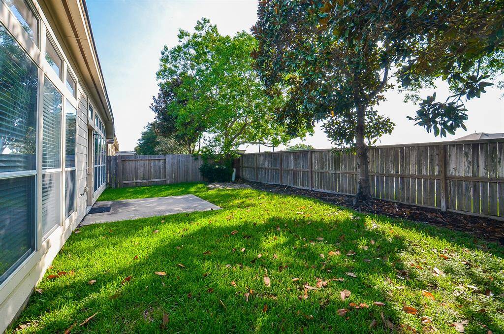 Fully fenced backyard offering privacy and a safe space for kids and pets to play.