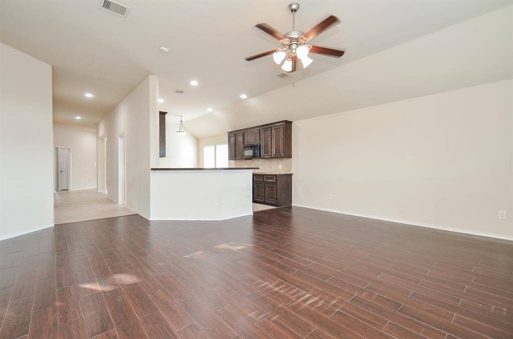 The kitchen boasts an open layout, seamlessly connecting to the spacious living area for effortless flow.