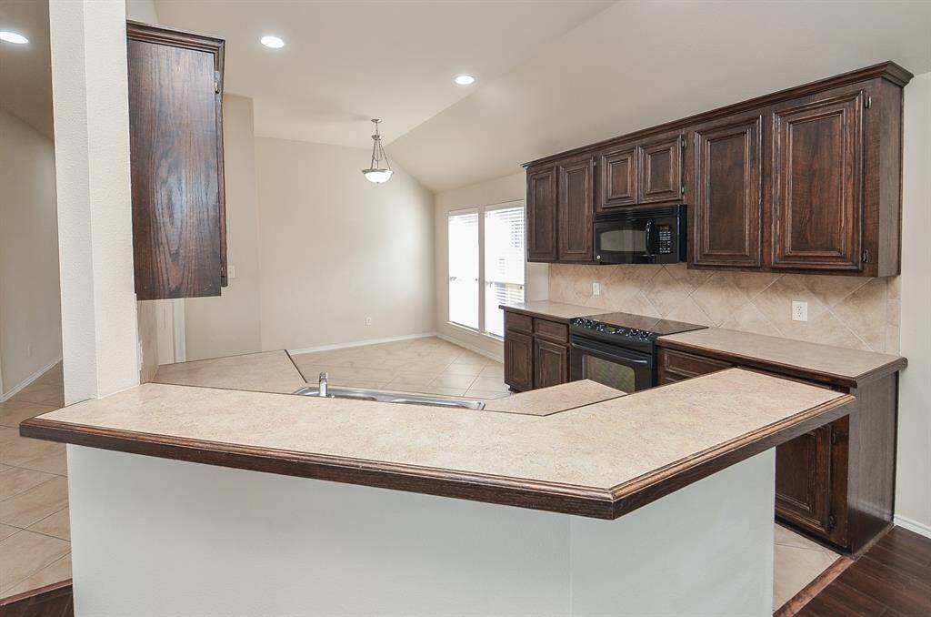 A convenient breakfast bar offers extra seating and a perfect spot for casual meals or entertaining.