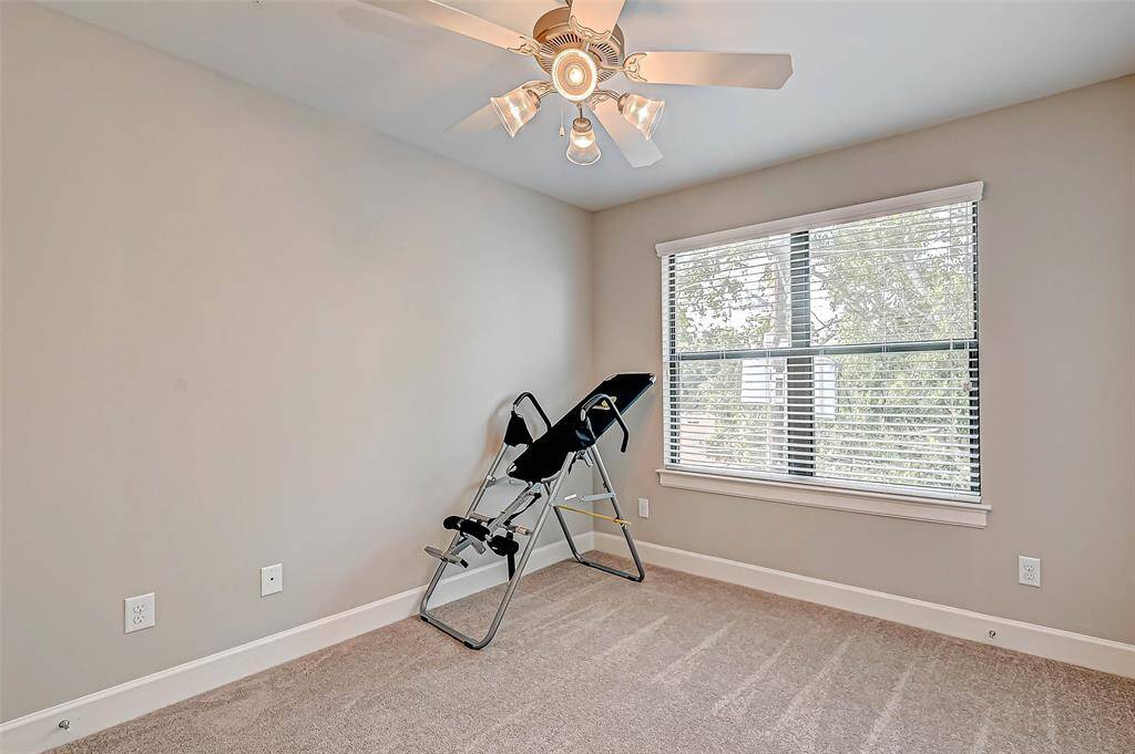 2nd bedroom with ceiling fan, softly lived in