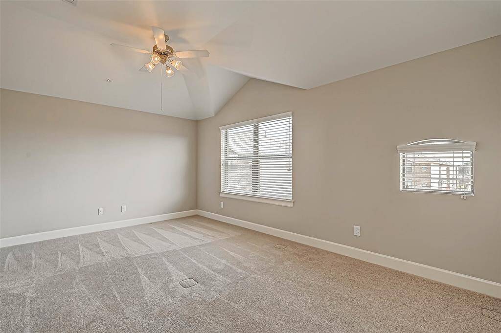 Large primary bedroom with ceiling fan