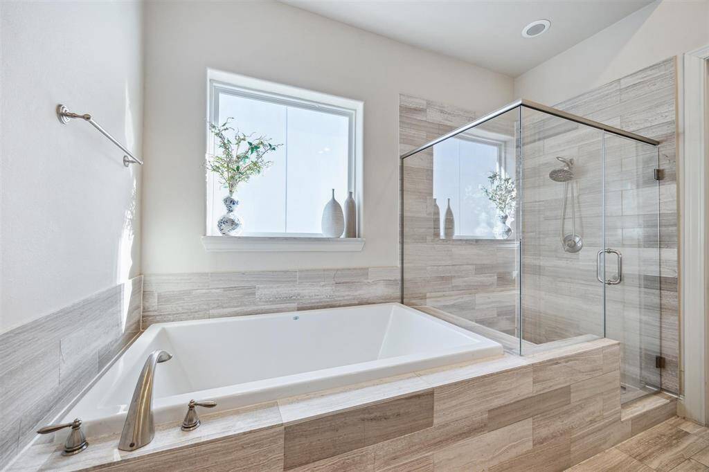 Large soaking tub with natural light.