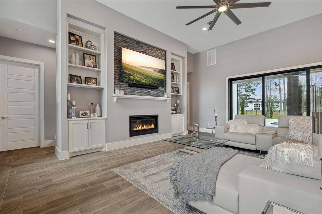 A cozy fireplace, set against a striking backdrop, adds both warmth and sophistication, blending a sense of homey comfort with luxurious elegance.