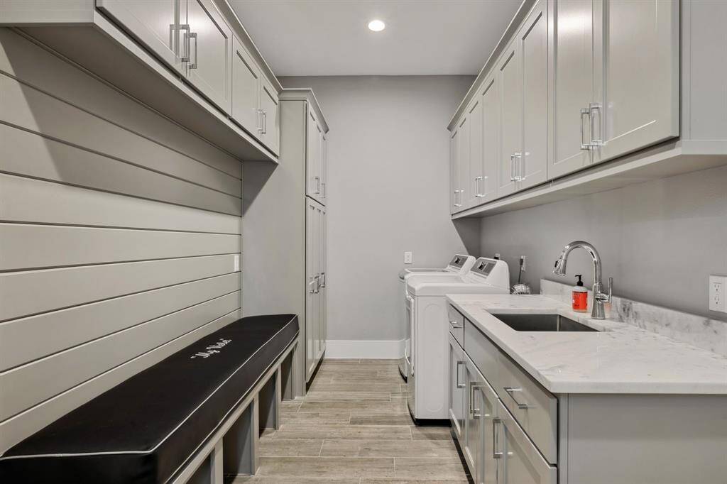 A spacious utility room featuring ample cabinetry for optimal storage and organization.