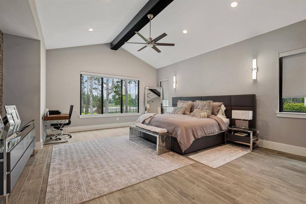 Expansive primary suite featuring large windows that showcase breathtaking views, with remote-controlled blinds for effortless convenience.