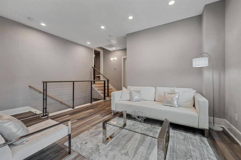 The second-floor game room offers a warm and welcoming ambiance, while the custom staircase railing adds a unique and sophisticated charm.