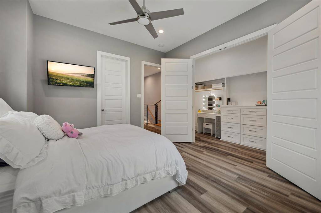 An expansive walk-in closet featuring a stylish vanity area, offering both functionality and elegance.