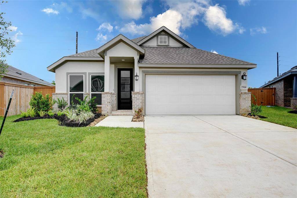Spacious driveway leading to a two-car garage