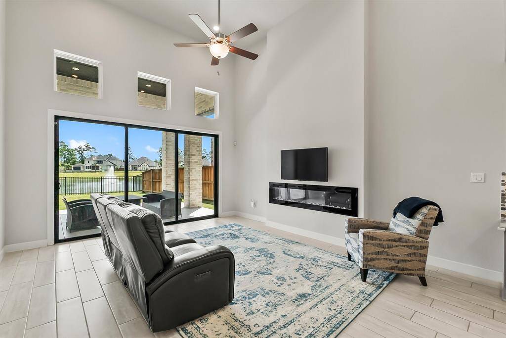 High ceilings and a slider wall give such a spacious and bright feel to this room.