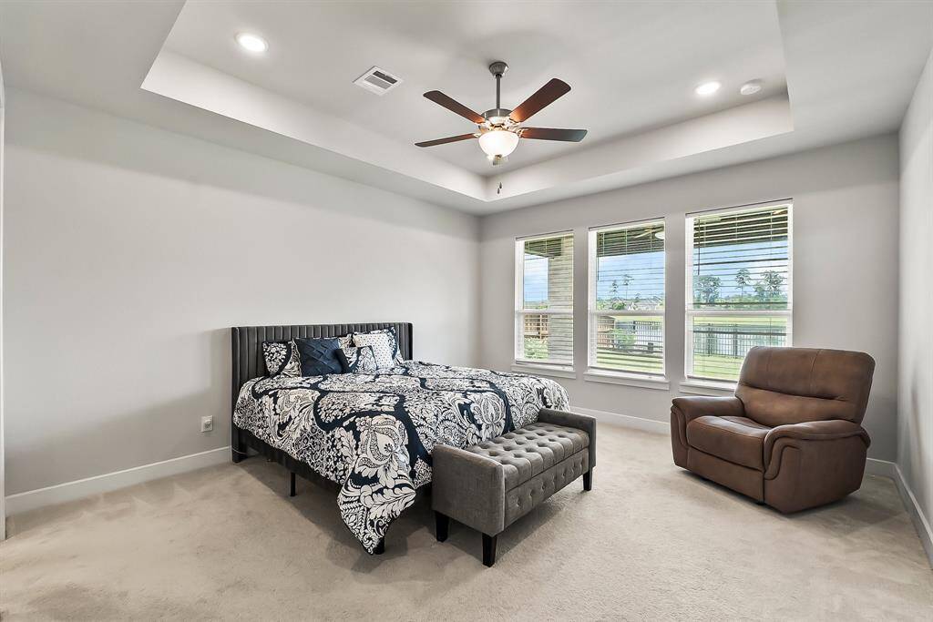 The primary suite offers beautiful views of the lake.