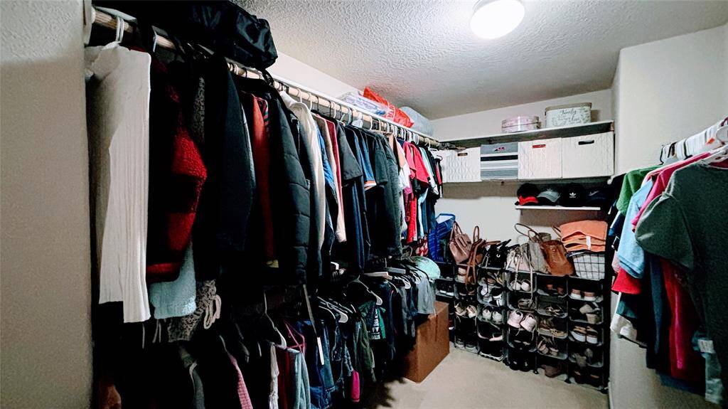 Spacious walk-in closet with ample hanging space and shelving.