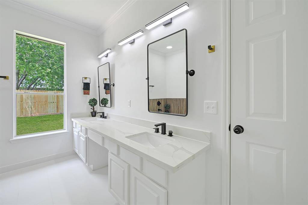 Dual sinks with modern lighting and mirrors