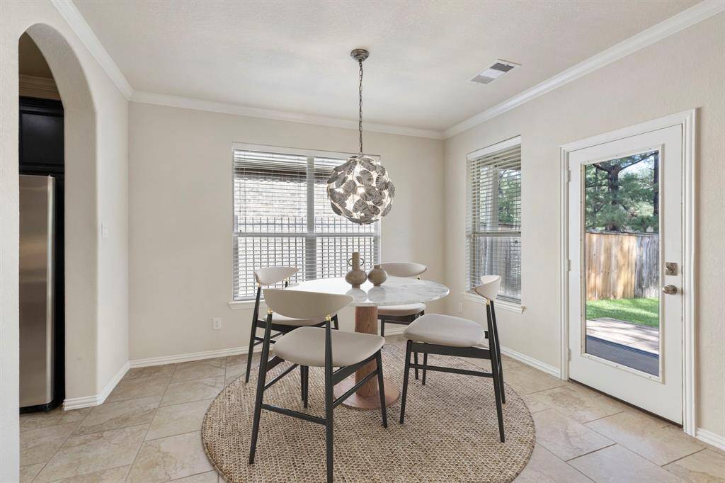Nestled just off the kitchen and seamlessly connected to the family room, the casual breakfast area is filled with natural light, thanks to surrounding windows that frame the space beautifully. *This image has been virtually staged.