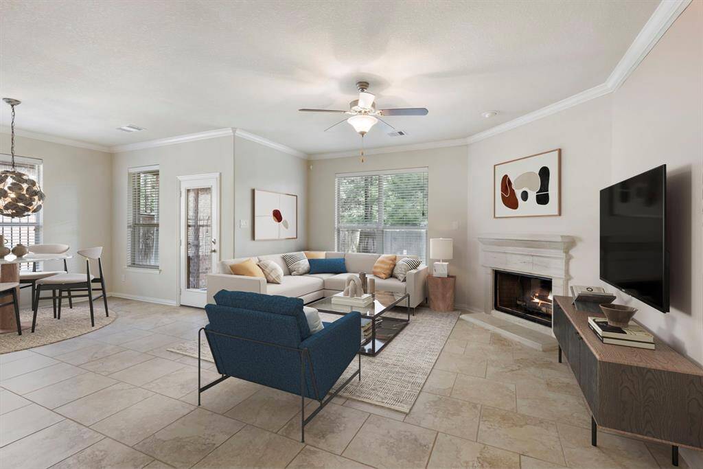 A cozy corner gas log fireplace with a cast stone mantle and surround serves as a beautiful focal point, adding warmth and architectural detail. *This image has been virtually staged.