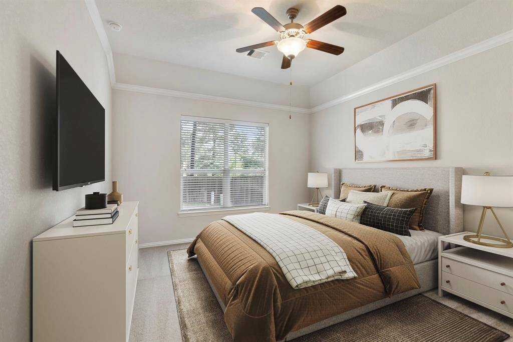Retreat to the primary suite featuring a soft neutral palette, fresh new carpet, elegant crown molding, and a peaceful window view overlooking the backyard. * This image has been virtually staged.