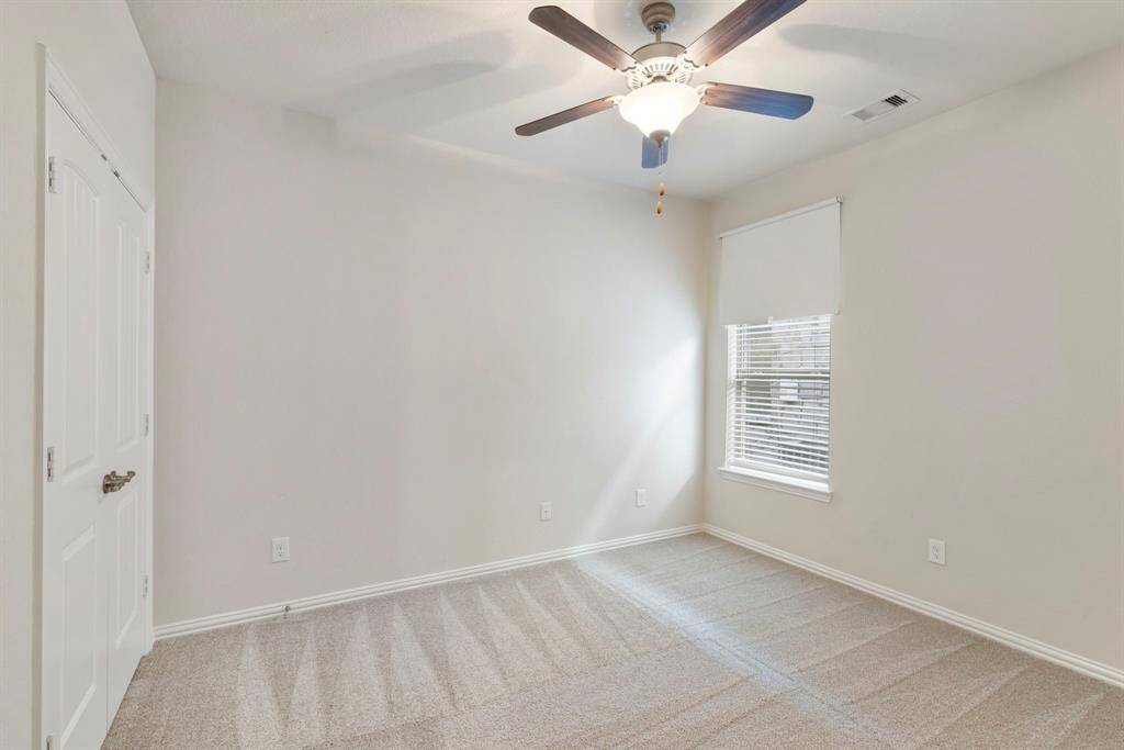 Secondary bedroom #2 has double door closet, fan and new carpet.  *This image has been virtually staged.