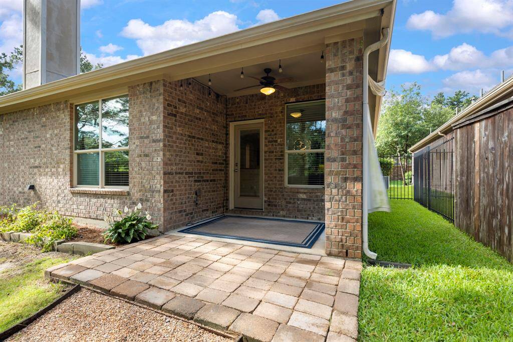 The covered patio offers a shaded haven, complete with a ceiling fan to keep you cool on warm days. This comfortable space invites you to unwind with a good book, enjoy outdoor meals, or simply take in the tranquil surroundings.