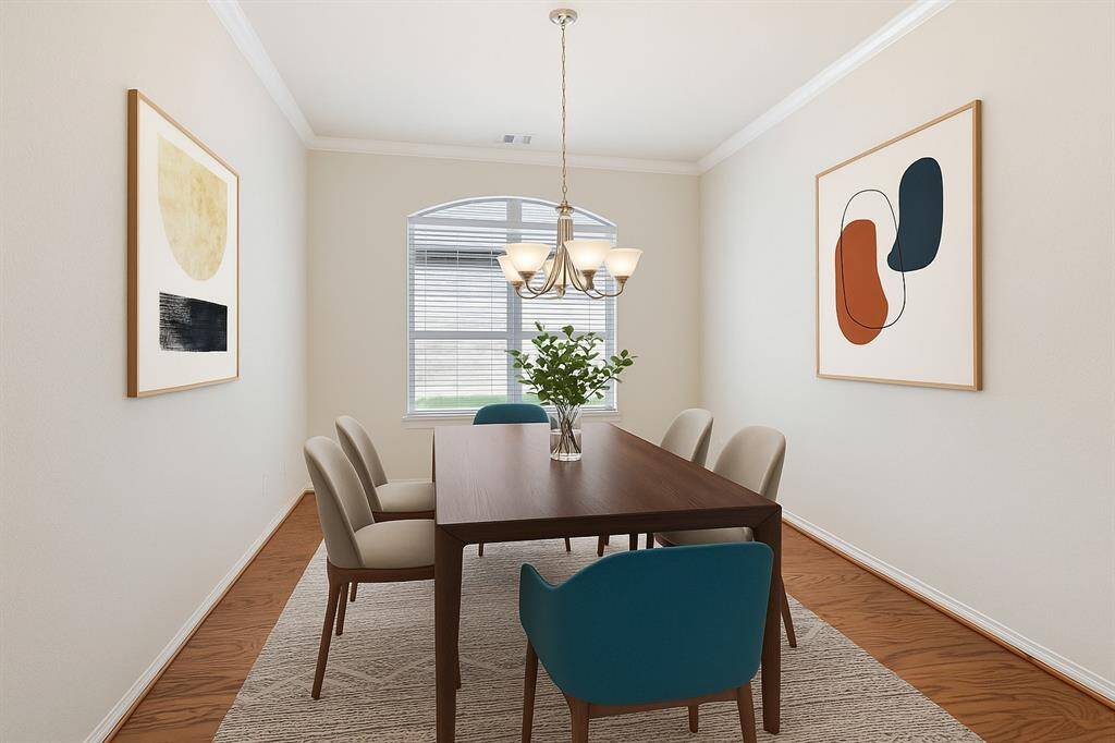 The separate formal dining room has high ceilings, crown moulding and large arched window.  The wood flooring adds warmth and sophistication, offering the perfect backdrop for gatherings or family dinners.  *This image has been virtually staged.