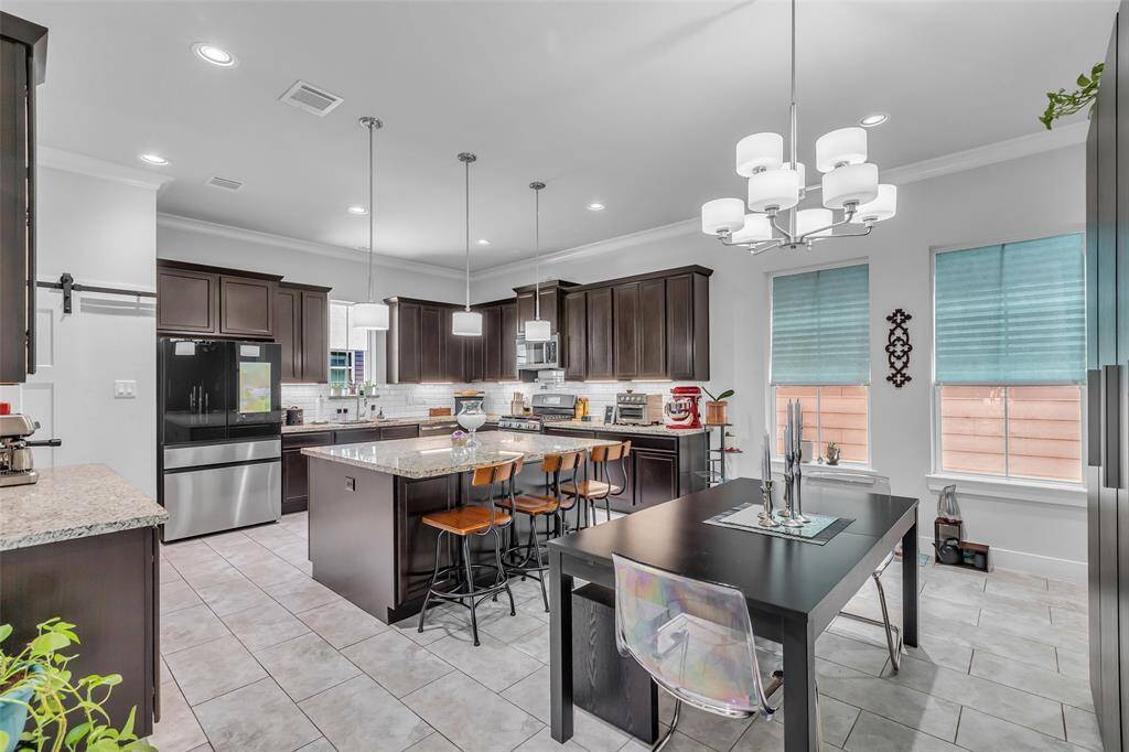 This view showcases the kitchen and dining room, conveniently positioned side by side to support easy meal prep and casual or formal dining.