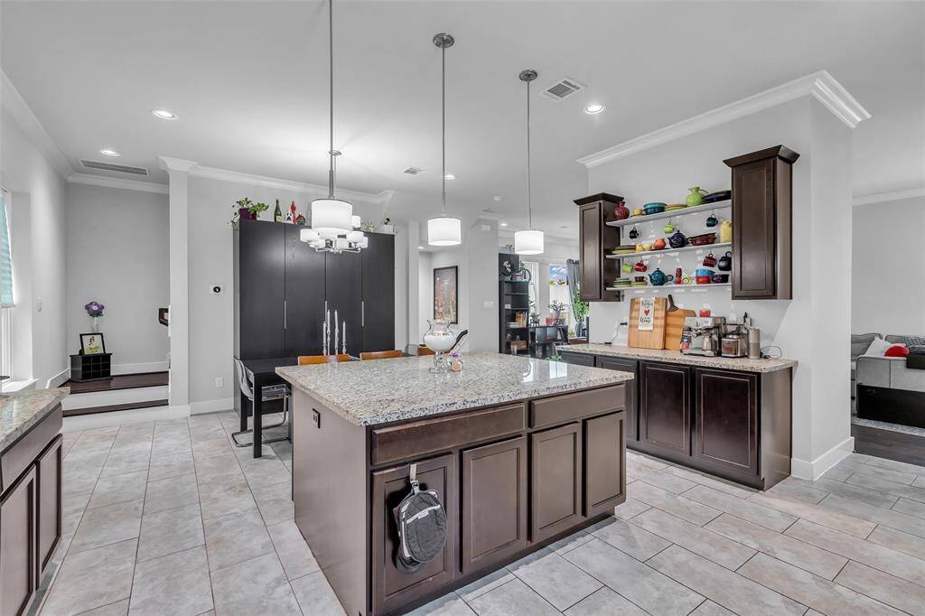 From the kitchen, enjoy a view that extends into the dining area and offers a partial glimpse of the living space, creating an open and connected feel.