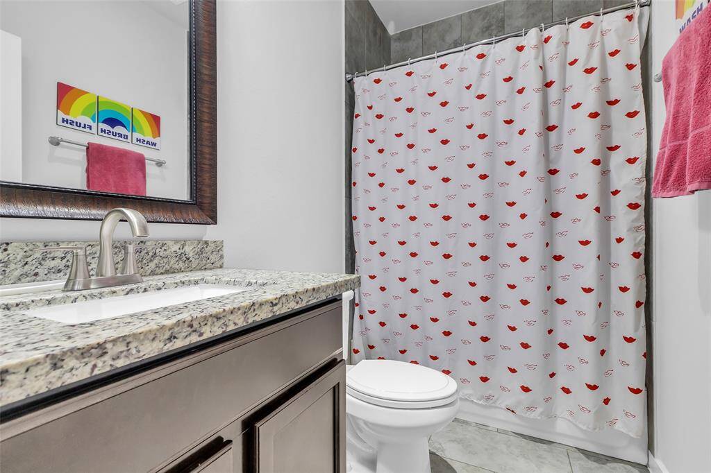 This common bathroom on the third floor includes a tub and shower combination for convenience.