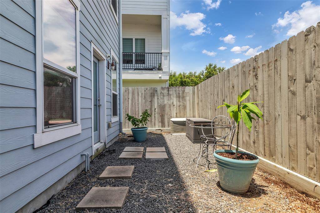 View the fully fenced backyard patio, providing a private outdoor space for relaxation and gatherings.
