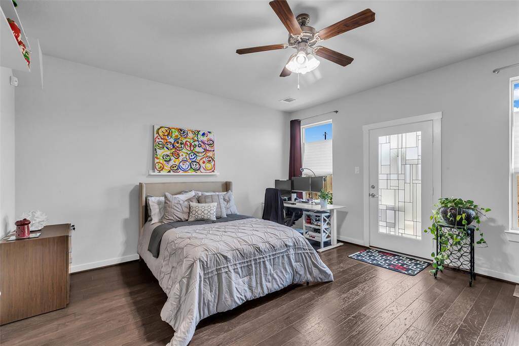 One of two primary bedrooms, this spacious first-floor suite provides added convenience and privacy. It features direct access to the back patio through a private entrance, creating an easy connection to the outdoor space.