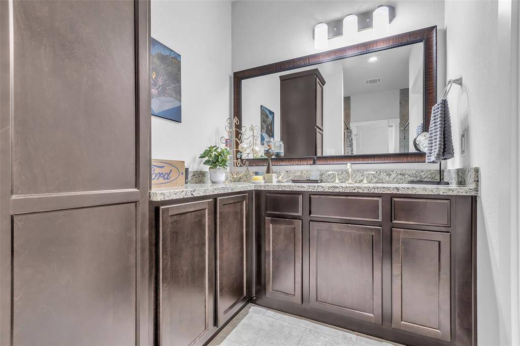 The first-floor main bathroom provides ample storage space to keep essentials organized and within reach.