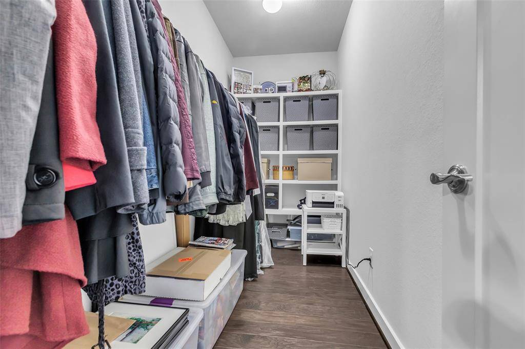 This walk-in closet, located in the first-floor main bedroom, provides generous storage space with built-in shelving and ample room for organization.