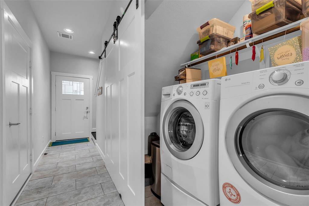 The laundry area is conveniently located at the end of the foyer, making it easily accessible while keeping it tucked away from the main living spaces.