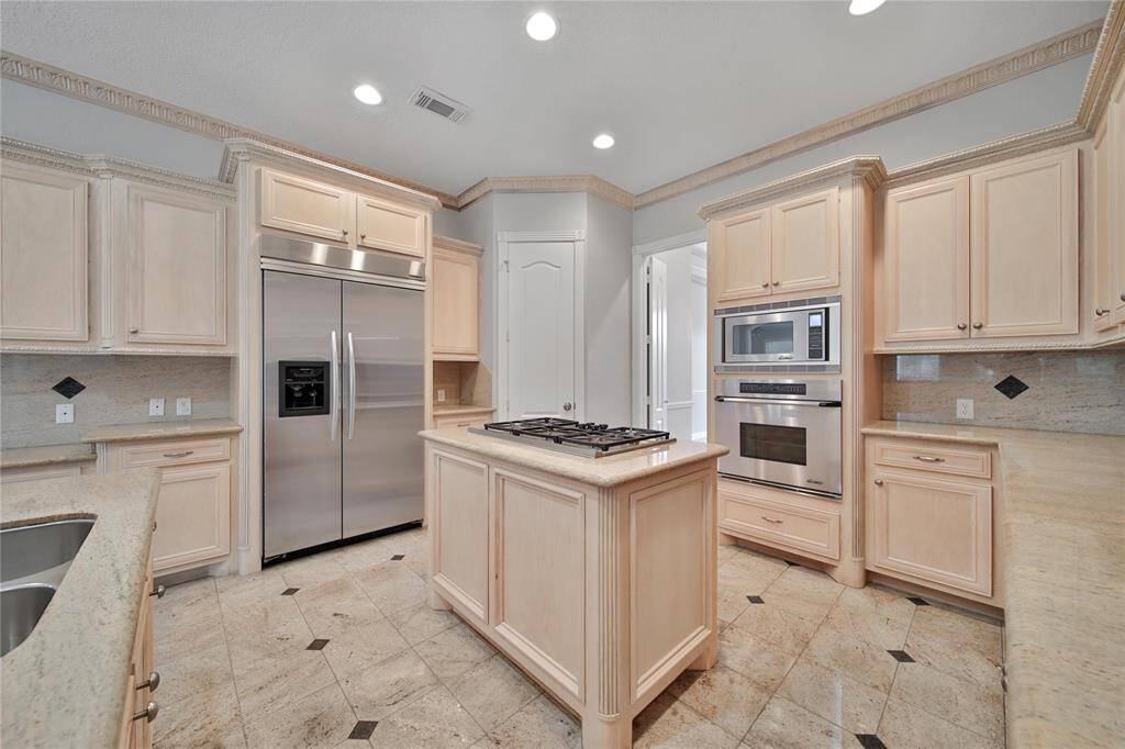 Chef's dream gourmet island kitchen with lots of cabinet and counter space, 5 burner gas range w/electric vent, Kitchenaid built in fridge and oversized oven.